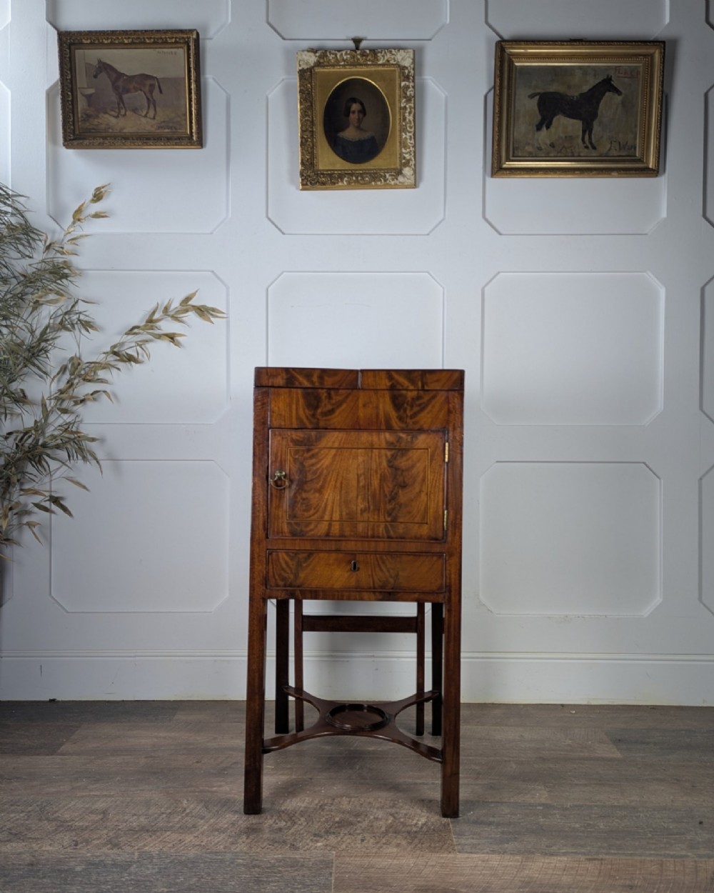 A Georgian Cuban mahogany fold-away washstand featuring an upright mirror, opened side leaves, a central cupboard, a lower drawer, and an X-frame stretcher. View VI