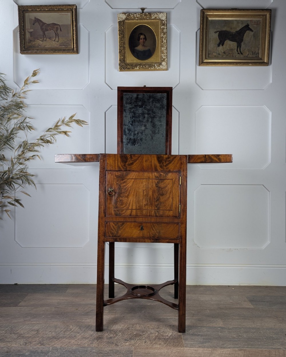 A Georgian Cuban mahogany fold-away washstand featuring an upright mirror, opened side leaves, a central cupboard, a lower drawer, and an X-frame stretcher. View VIII