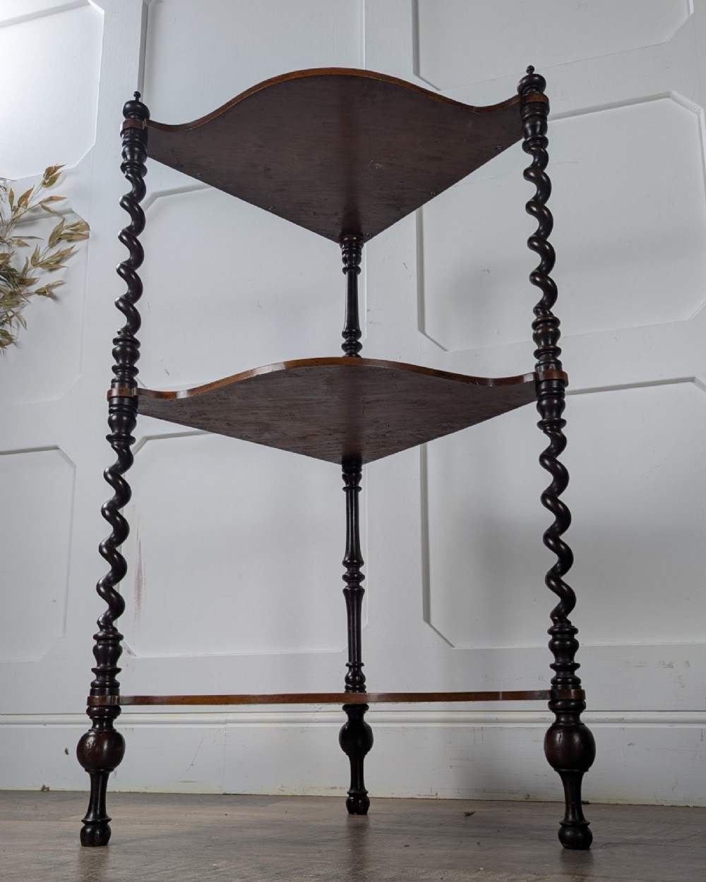 A Victorian dark mahogany three-tier corner whatnot featuring spiralled barley twist front supports and finial details. View II