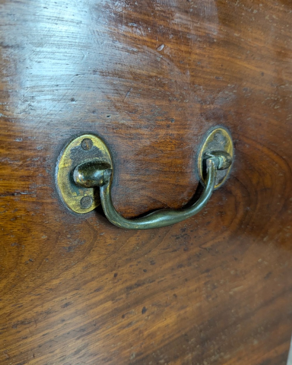 A Georgian dark mahogany cellarette featuring a hinged top lid, a lower drawer with wooden turned knobs, brass side handles, and square tapered legs on brass castors. View IX