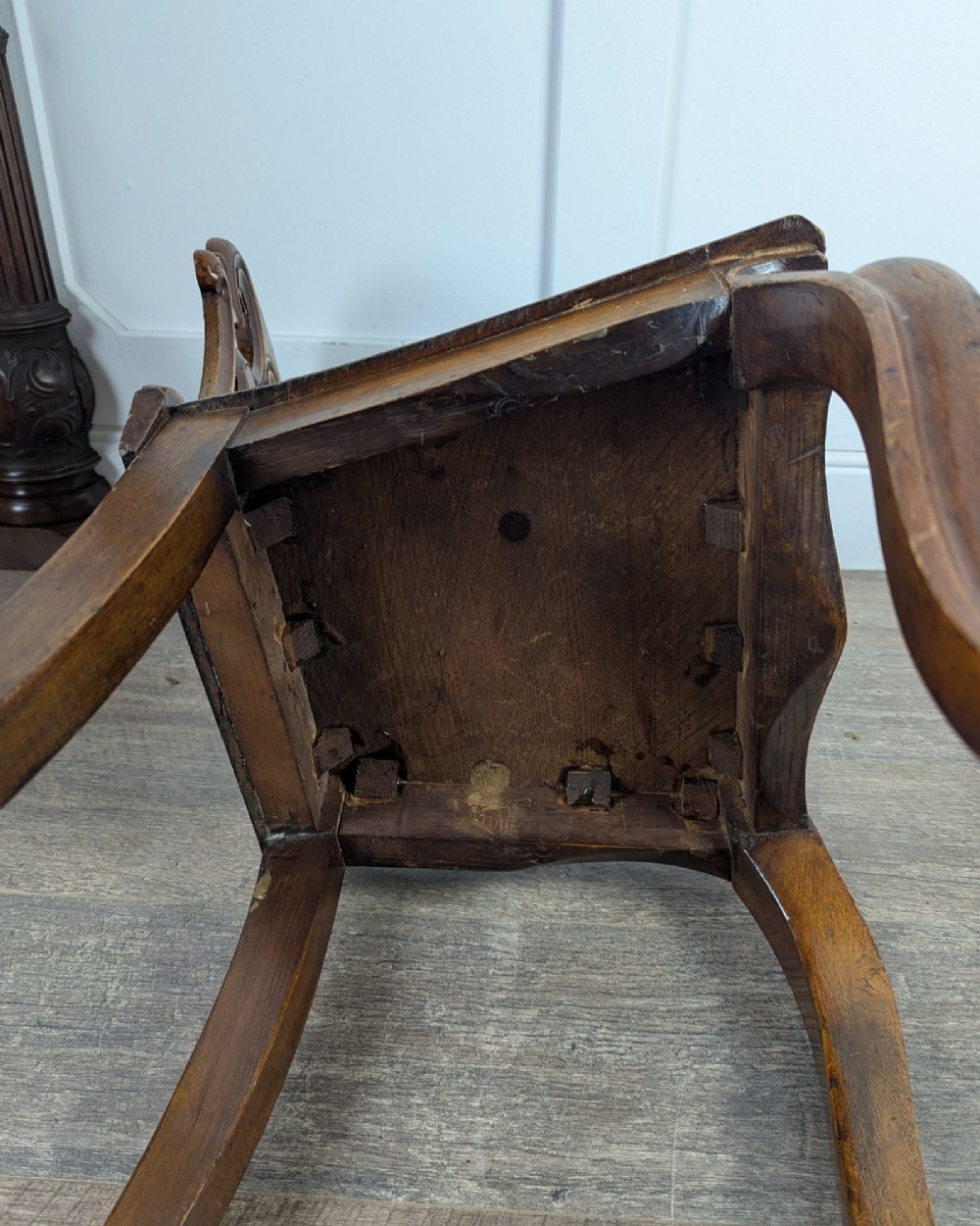A Victorian carved solid oak hall chair featuring an openwork shield back, a solid timber seat, and shaped cabriole front legs. View XII