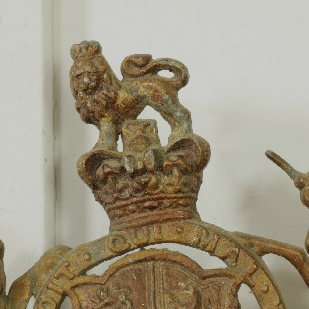 A Victorian cast metal relief plaque depicting the Royal Coat of Arms of the United Kingdom flanked by a lion and unicorn. View IV