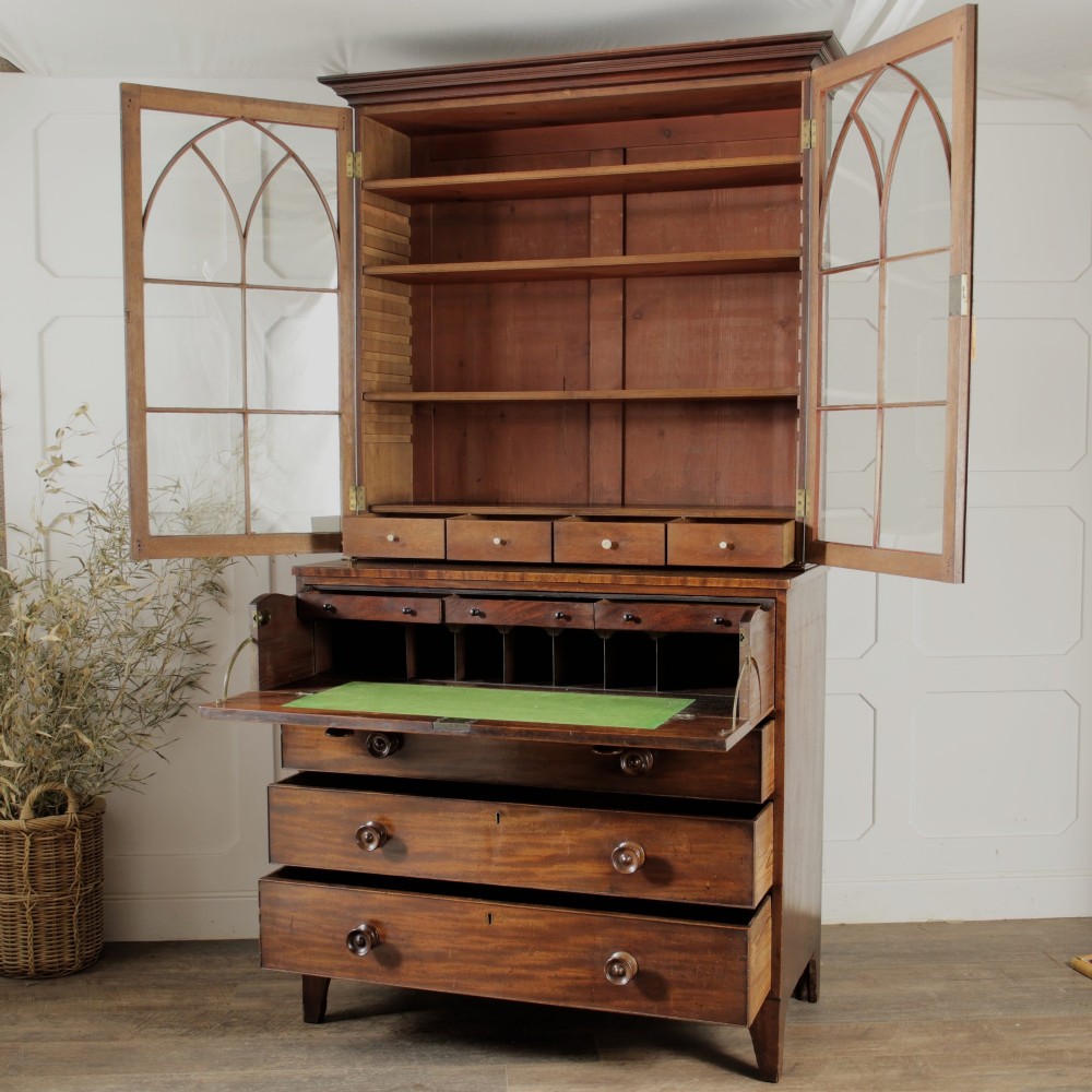 A 19th-century mahogany secretaire bookcase featuring an upper glazed cabinet with gothic arch doors and a lower chest of drawers. View II