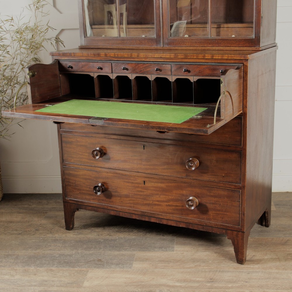 A 19th-century mahogany secretaire bookcase featuring an upper glazed cabinet with gothic arch doors and a lower chest of drawers. View VI
