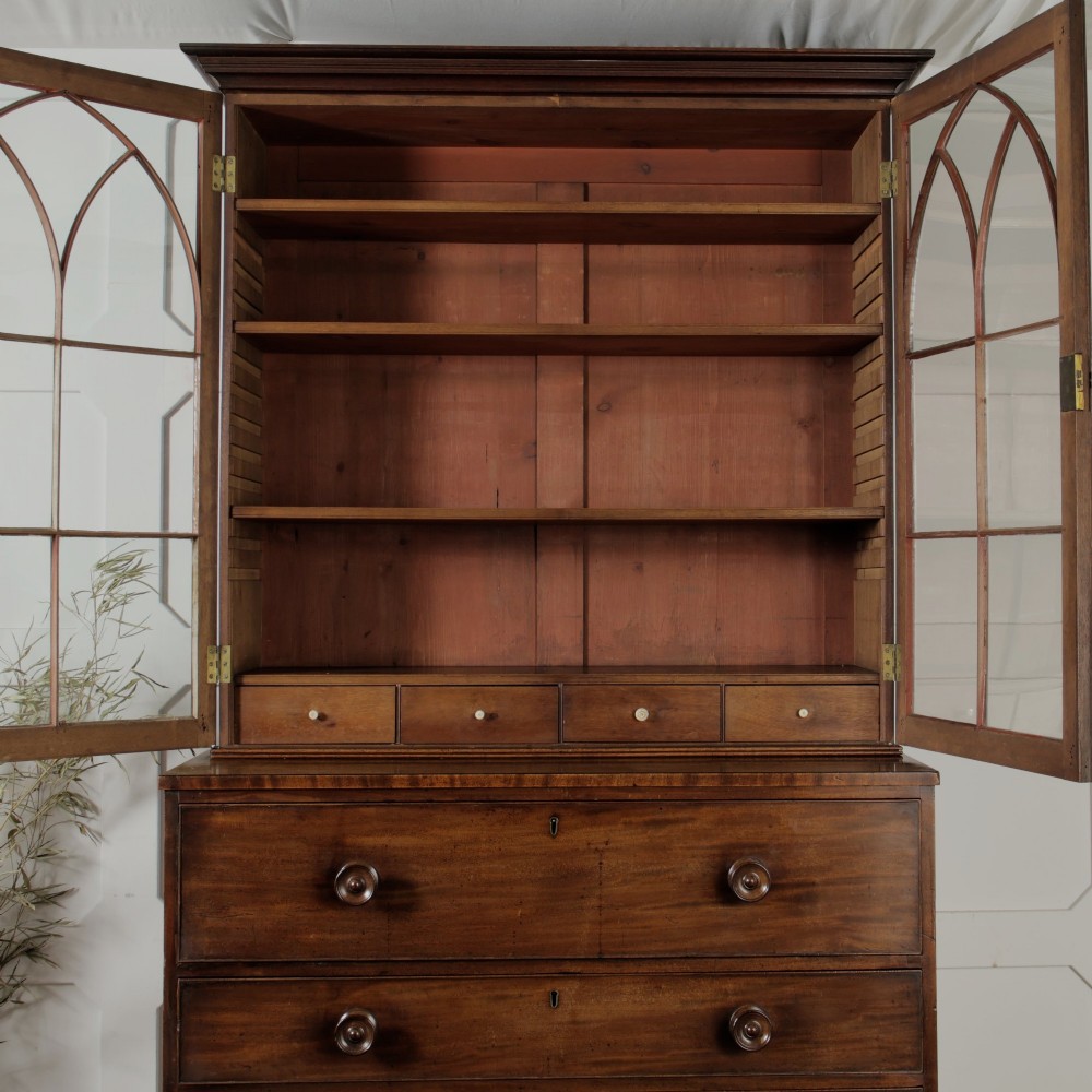 A 19th-century mahogany secretaire bookcase featuring an upper glazed cabinet with gothic arch doors and a lower chest of drawers. View IX