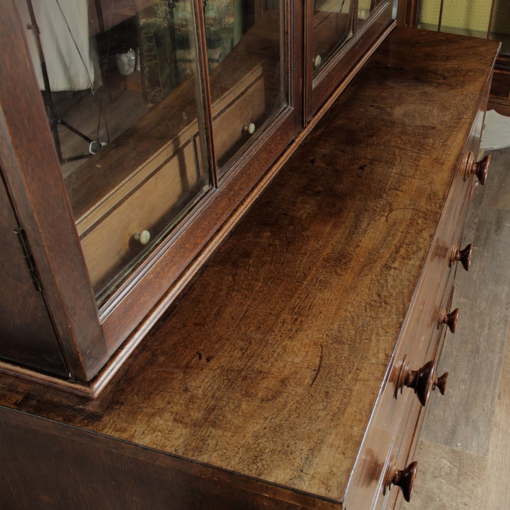 A 19th-century mahogany secretaire bookcase featuring an upper glazed cabinet with gothic arch doors and a lower chest of drawers. View XII