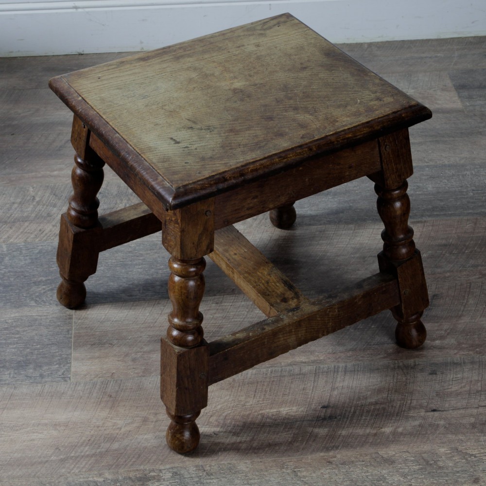 A pair of 19th-century oak joint stools featuring square tops, turned baluster legs, pegged joinery, and low perimeter stretchers. View IV