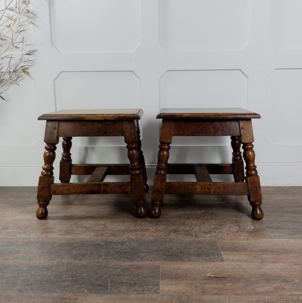 A pair of 19th-century oak joint stools featuring square tops, turned baluster legs, pegged joinery, and low perimeter stretchers. View XIII