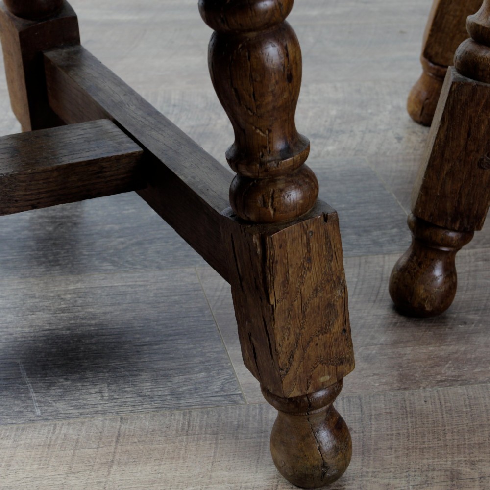 A pair of 19th-century oak joint stools featuring square tops, turned baluster legs, pegged joinery, and low perimeter stretchers. View XIV