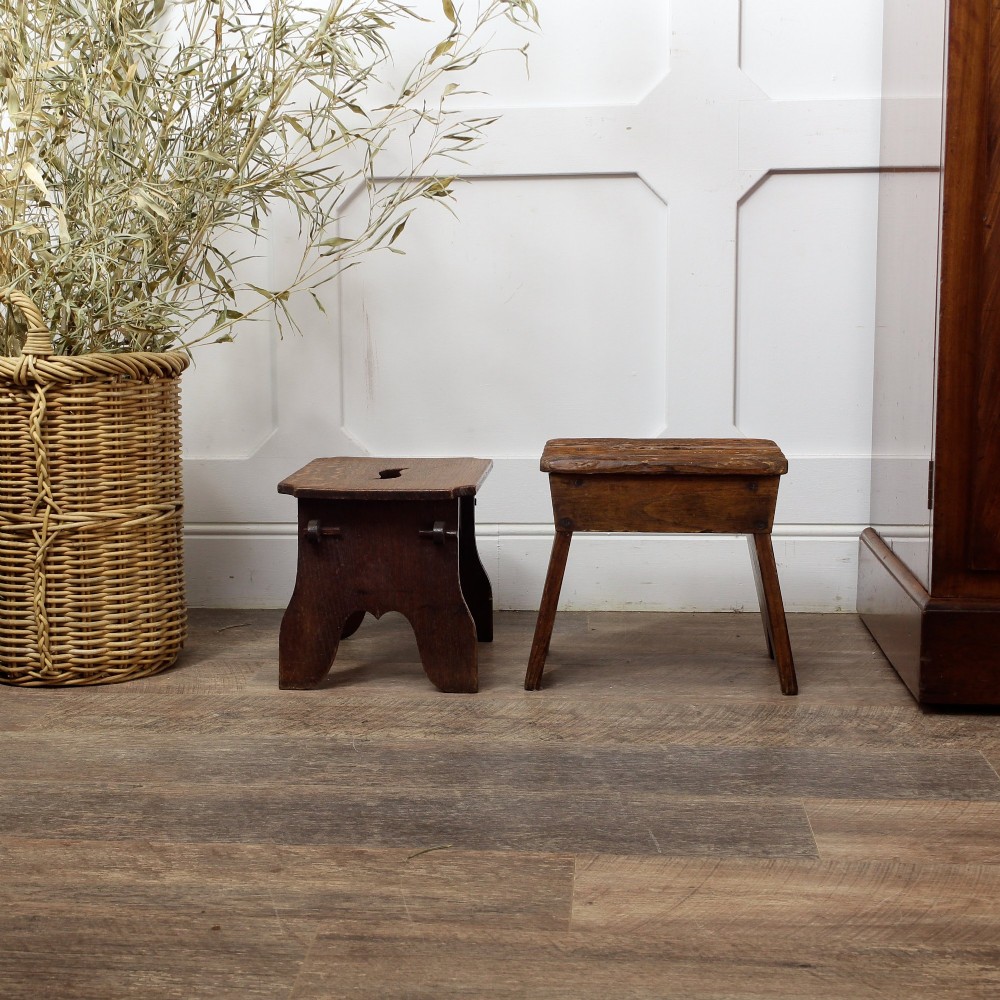 A pair of small 19th-century wooden country stools constructed from dark oak and pine with cut-out trestle legs. View VI
