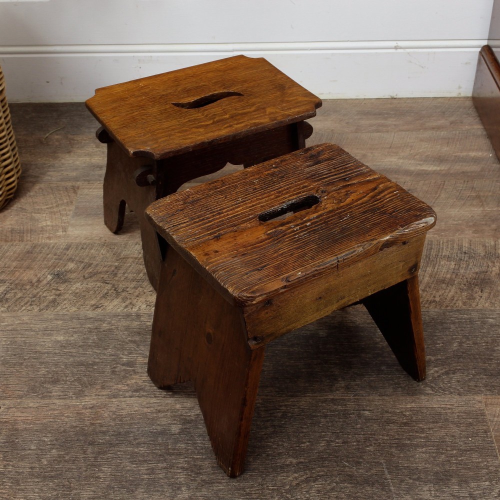 A pair of small 19th-century wooden country stools constructed from dark oak and pine with cut-out trestle legs. View IX