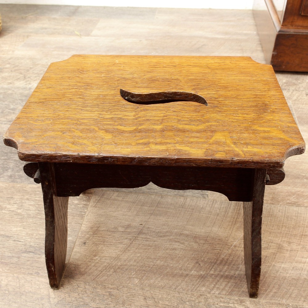 A pair of small 19th-century wooden country stools constructed from dark oak and pine with cut-out trestle legs. View XII