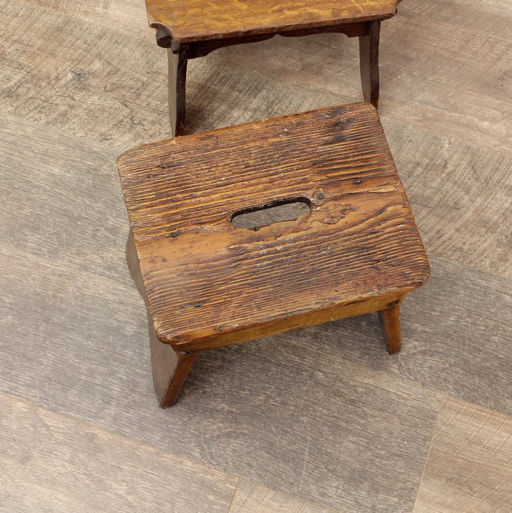 A pair of small 19th-century wooden country stools constructed from dark oak and pine with cut-out trestle legs. View XIII