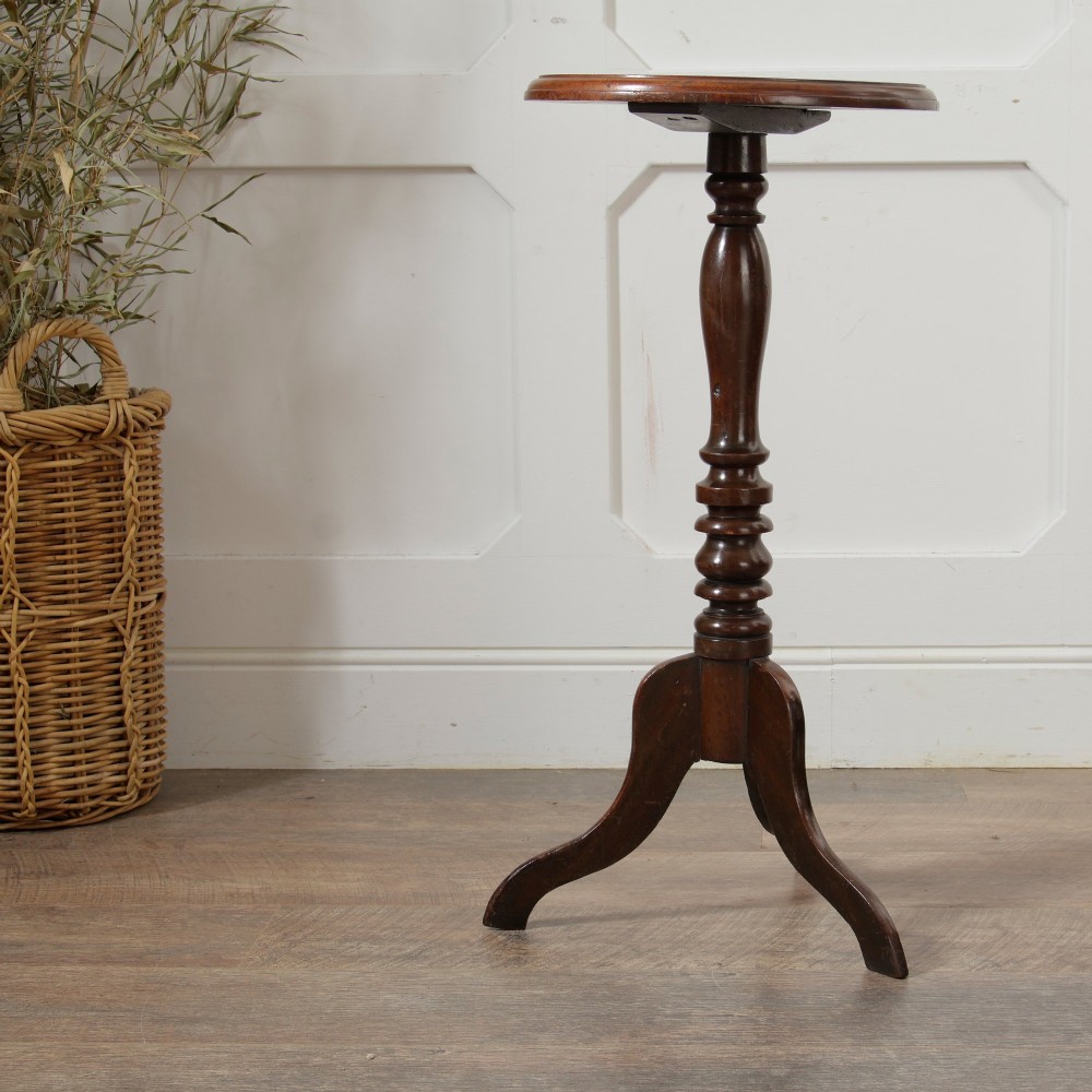 A Victorian dark mahogany pedestal wine table featuring a round top, a turned central column, and three curved tripod legs. View II