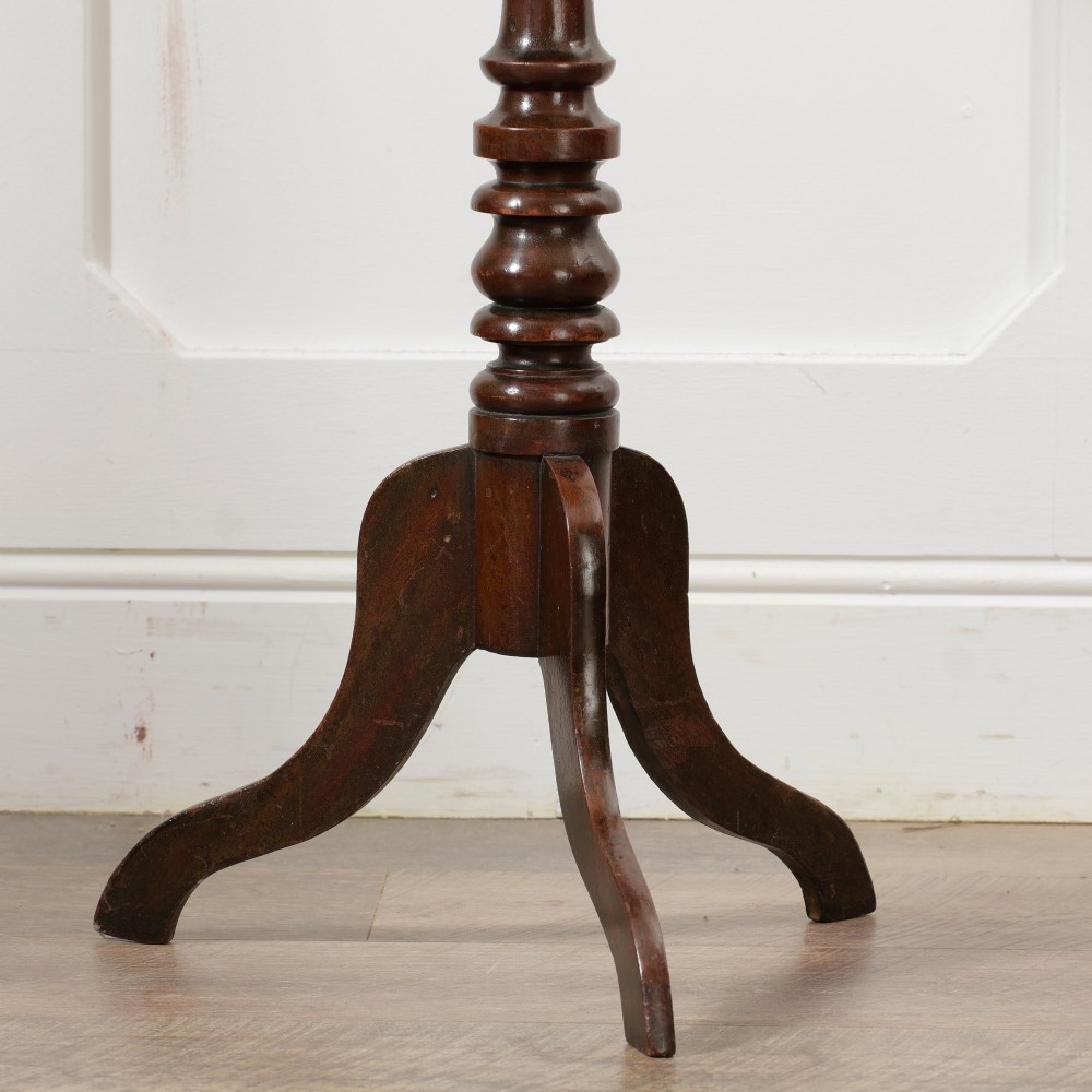 A Victorian dark mahogany pedestal wine table featuring a round top, a turned central column, and three curved tripod legs. View VI