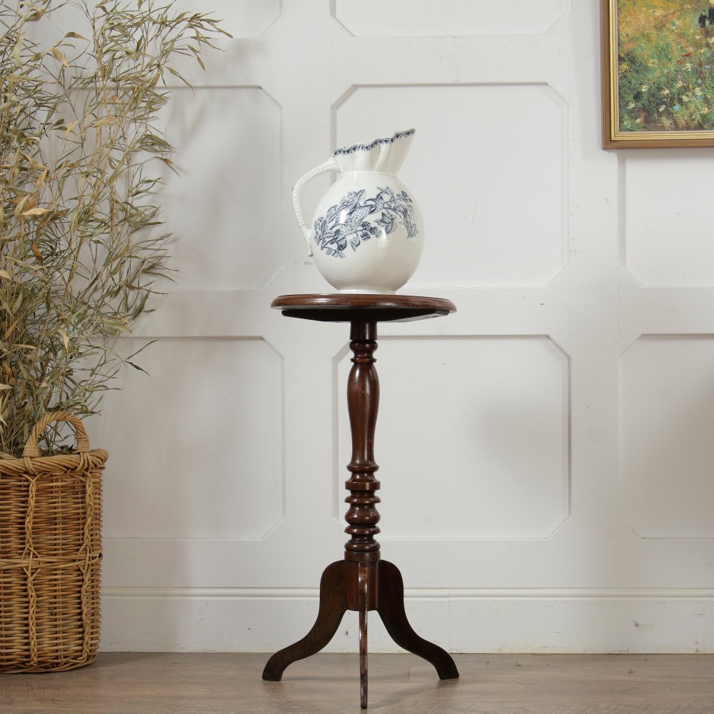 A Victorian dark mahogany pedestal wine table featuring a round top, a turned central column, and three curved tripod legs. View VIII