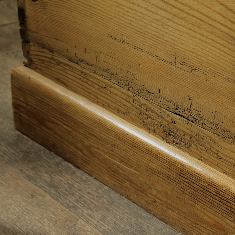 A rectangular Victorian pitch pine storage trunk featuring visible dovetail joinery, an iron keyhole escutcheon, metal side handles, and a plinth base. View VIII