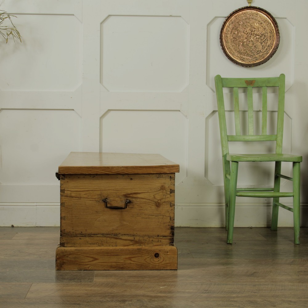 A rectangular Victorian pitch pine storage trunk featuring visible dovetail joinery, an iron keyhole escutcheon, metal side handles, and a plinth base. View XIII