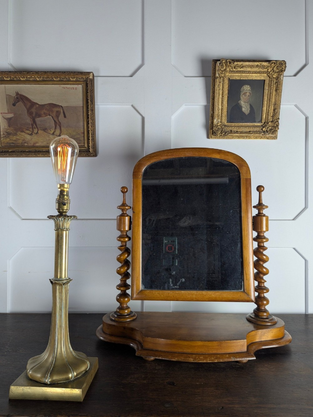 A Victorian satinwood toilet mirror featuring twin barley twist uprights, a curved base, and an arched tilting frame with mercury glass. View II