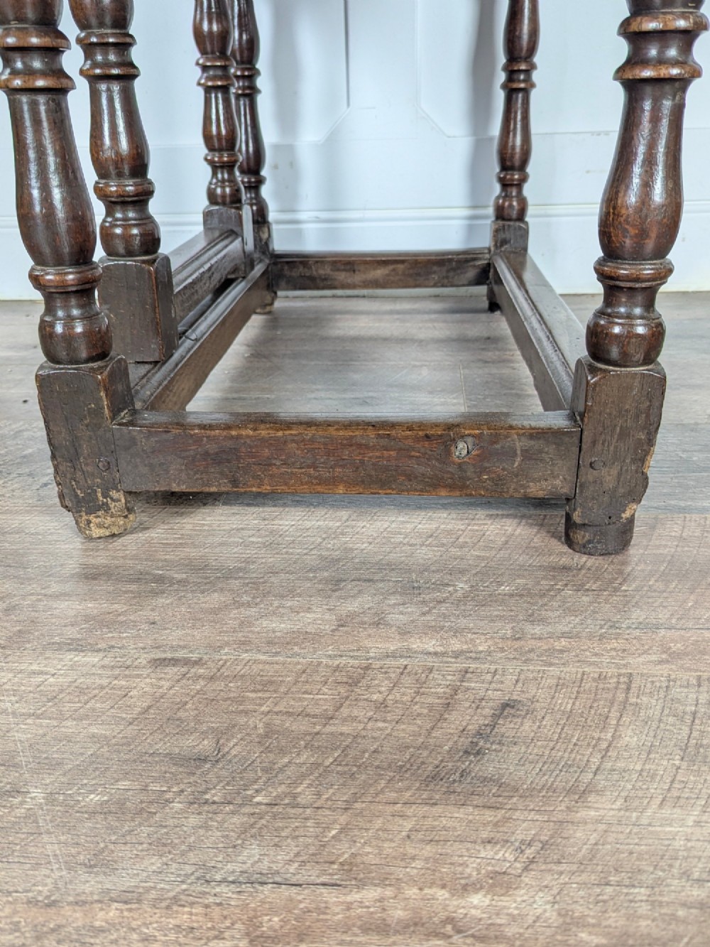 An eighteenth-century dark oak gateleg table with drop leaves, turned legs, stretchers, and a single end drawer. View VI