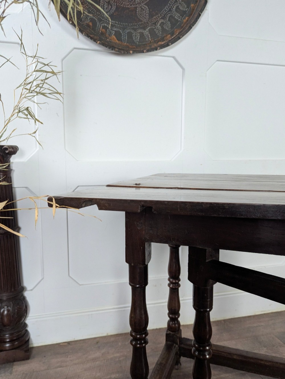 An eighteenth-century dark oak gateleg table with drop leaves, turned legs, stretchers, and a single end drawer. View XII