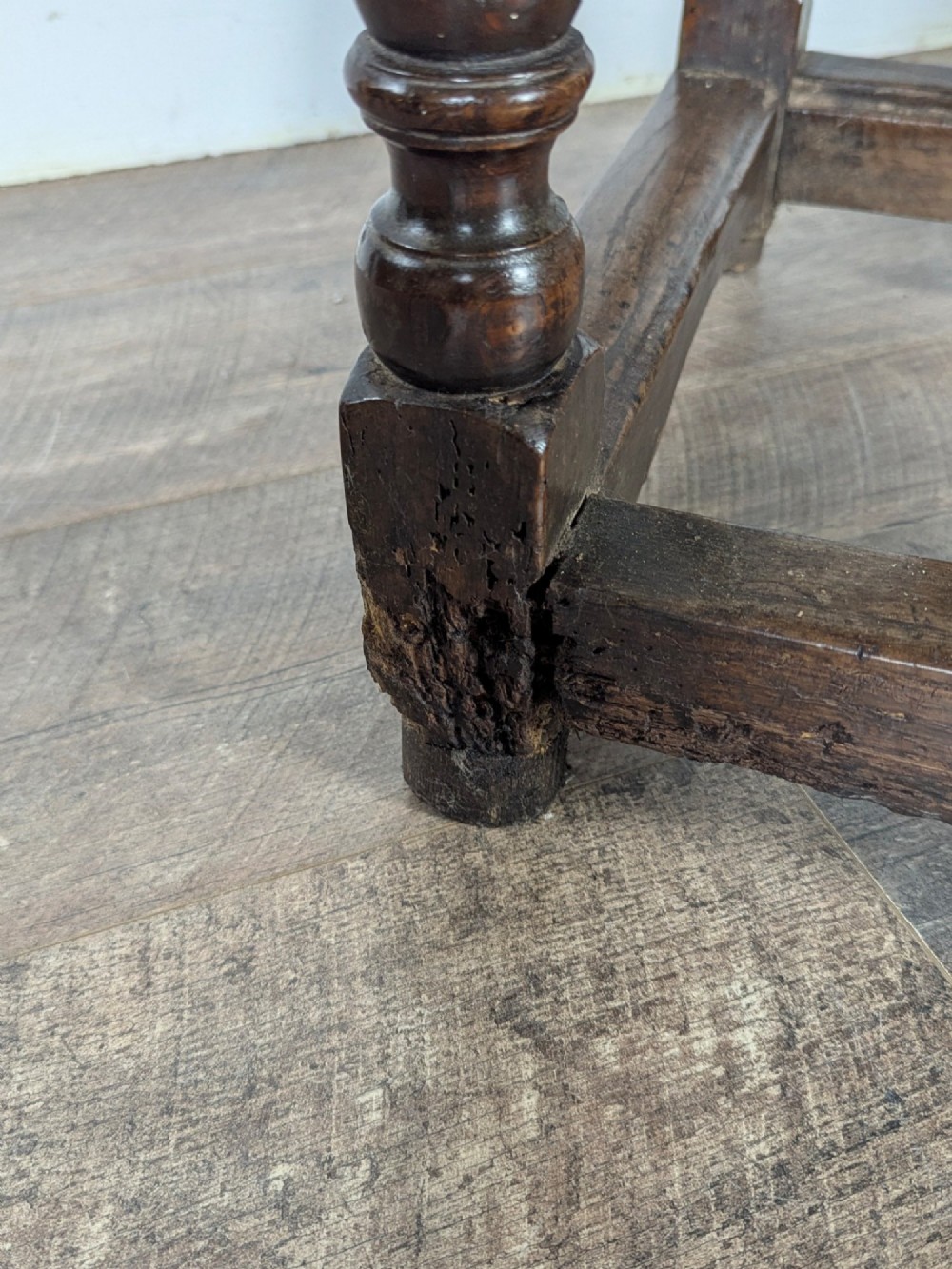An eighteenth-century dark oak gateleg table with drop leaves, turned legs, stretchers, and a single end drawer. View XIII