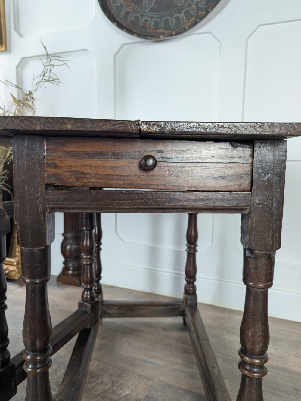 An eighteenth-century dark oak gateleg table with drop leaves, turned legs, stretchers, and a single end drawer. View XIV