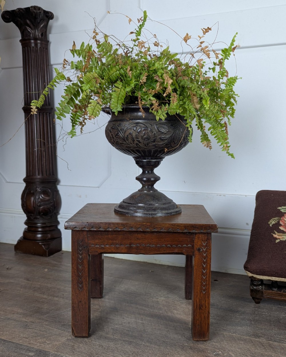 A rectangular dark oak low stool featuring hand-carved notch decorations along the apron and straight legs. View VI