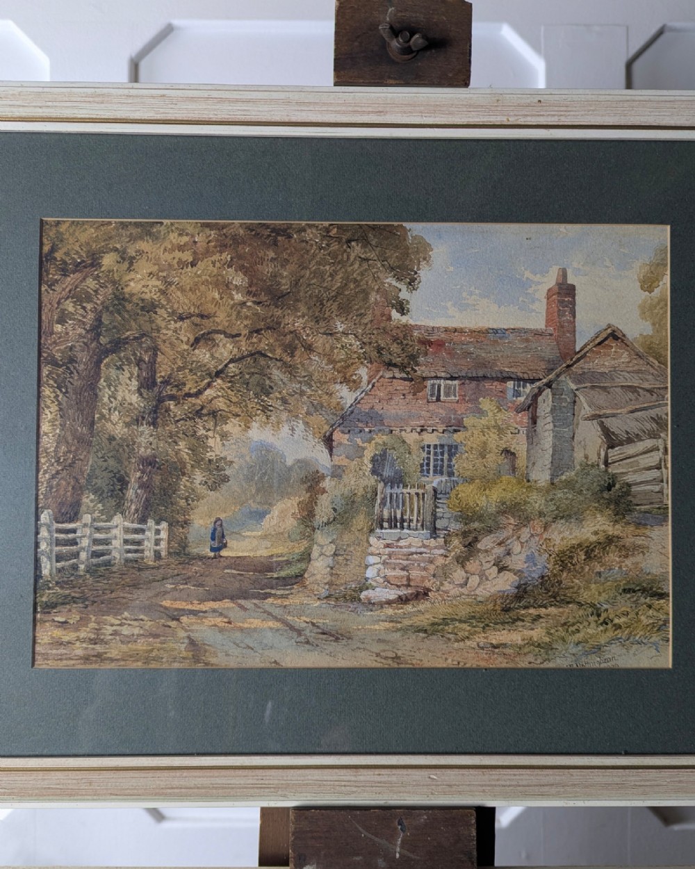Pair of 1879 Victorian watercolour paintings depicting rural English cottage landscapes, presented in dark green mounts and light wood frames. View II