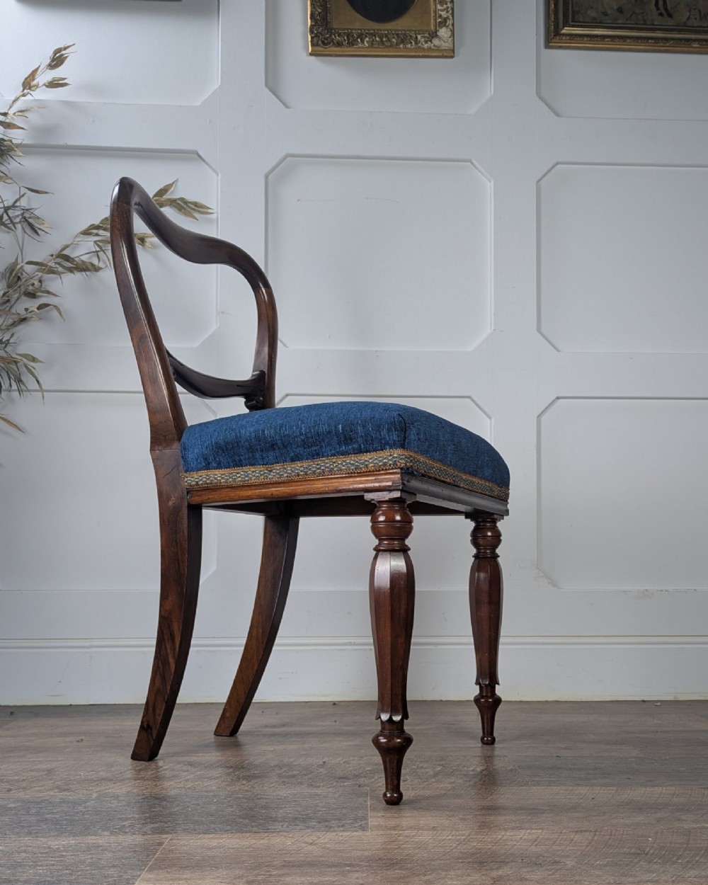 A Victorian rosewood side chair with a curved kidney backrest, turned front legs, and a navy blue velvet upholstered seat. View II