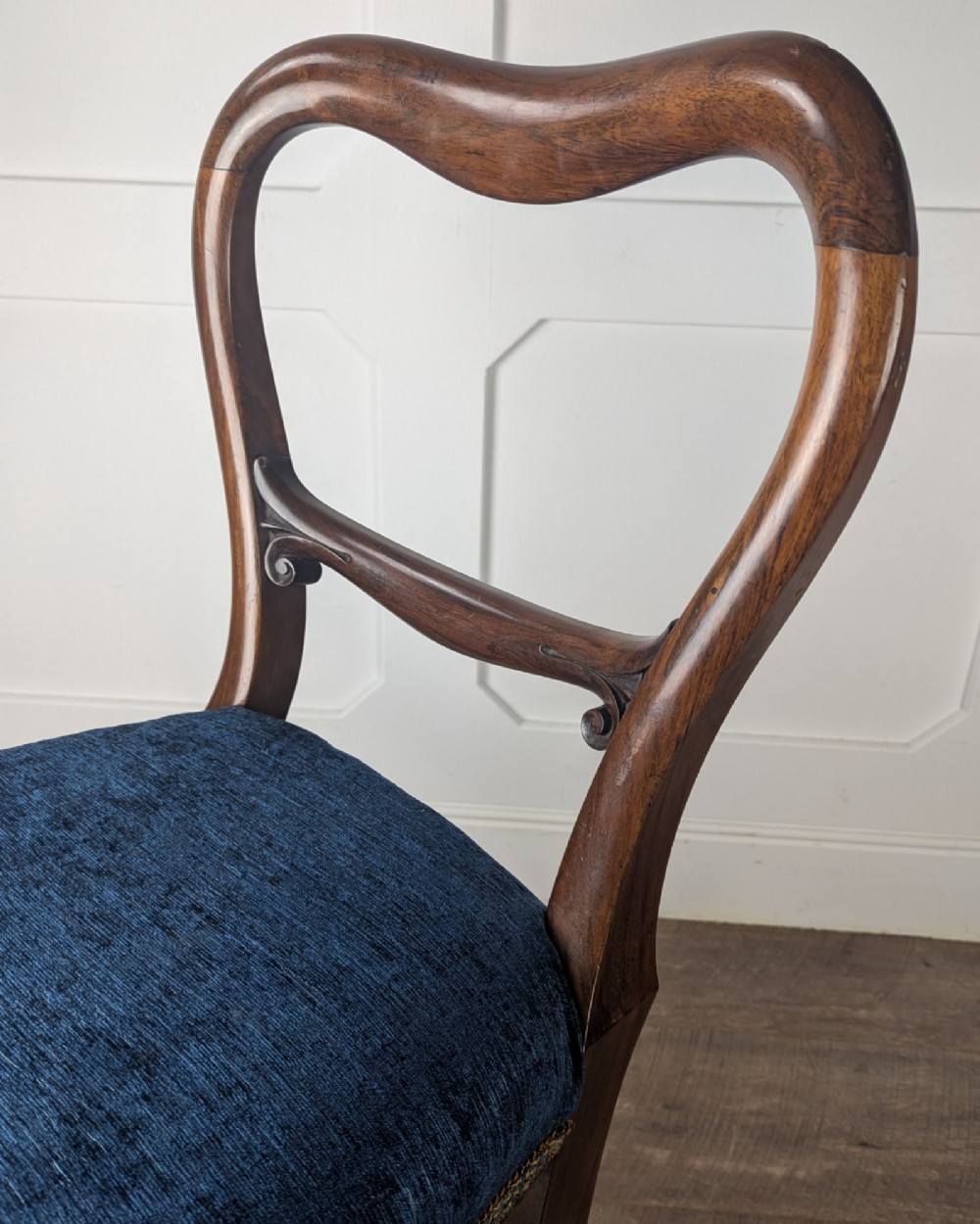A Victorian rosewood side chair with a curved kidney backrest, turned front legs, and a navy blue velvet upholstered seat. View IX