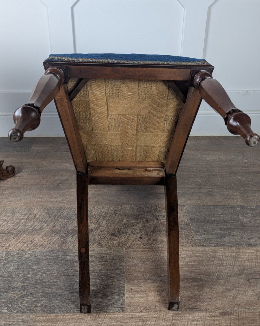 A Victorian rosewood side chair with a curved kidney backrest, turned front legs, and a navy blue velvet upholstered seat. View XIV