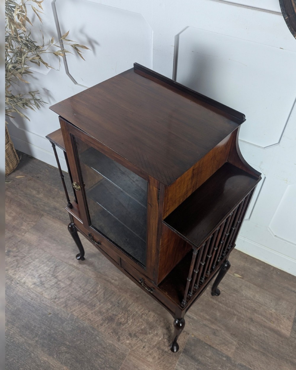 An early 20th-century mahogany music cabinet featuring a central glazed door flanked by turned spindle galleries, set above two drawers on cabriole legs. View XIII
