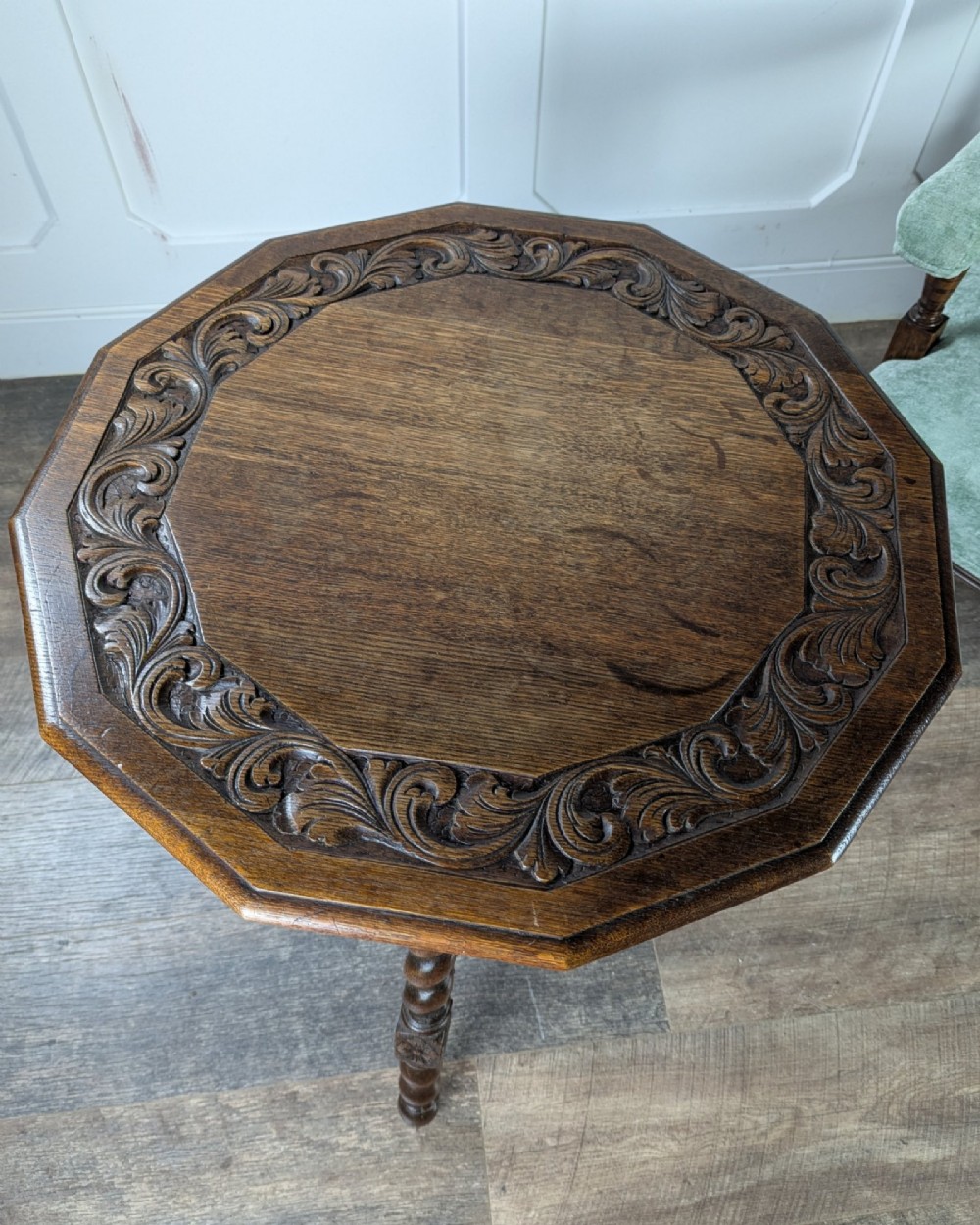 A late Victorian solid dark oak side table with an octagonal top, three barley twist legs, carved block knees, and a central turned finial on the stretcher base. View III