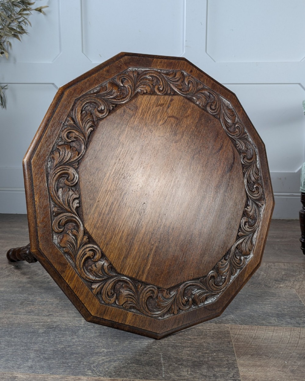 A late Victorian solid dark oak side table with an octagonal top, three barley twist legs, carved block knees, and a central turned finial on the stretcher base. View VII