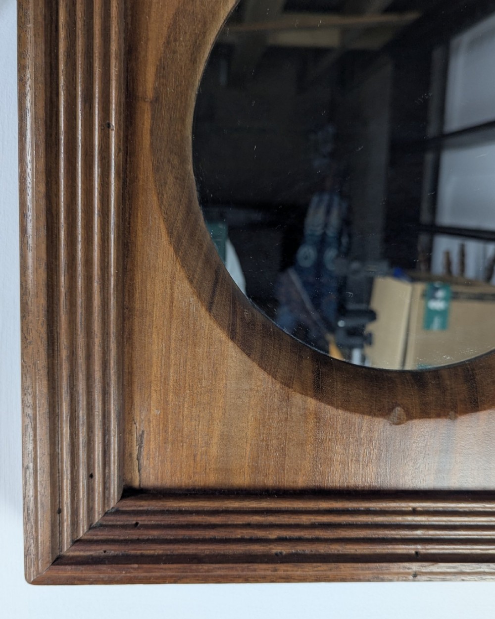 A square dark mahogany frame featuring stepped outer mouldings and a central circular mirror reflection. View V