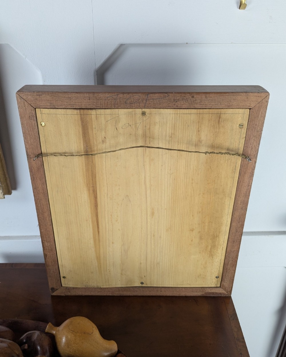 A square dark mahogany frame featuring stepped outer mouldings and a central circular mirror reflection. View VI