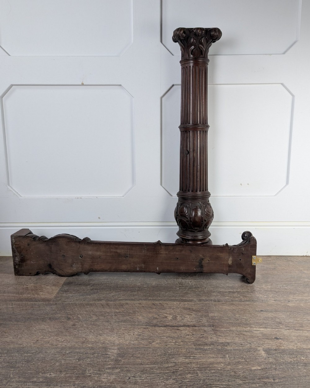 A pair of dark carved mahogany half columns featuring Corinthian capitals, reeded shafts, and carved bulbous bases. View VIII