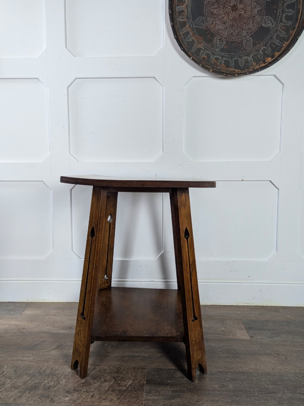 A solid oak Art Nouveau side table featuring splayed legs with spade-shaped cutouts and a lower square undertier shelf. View VII