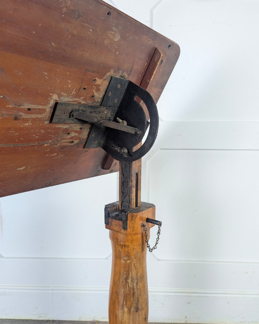 An early 20th-century pine reading table featuring an adjustable tilting top, a central turned support column, and a shaped base on small castors. View XIII
