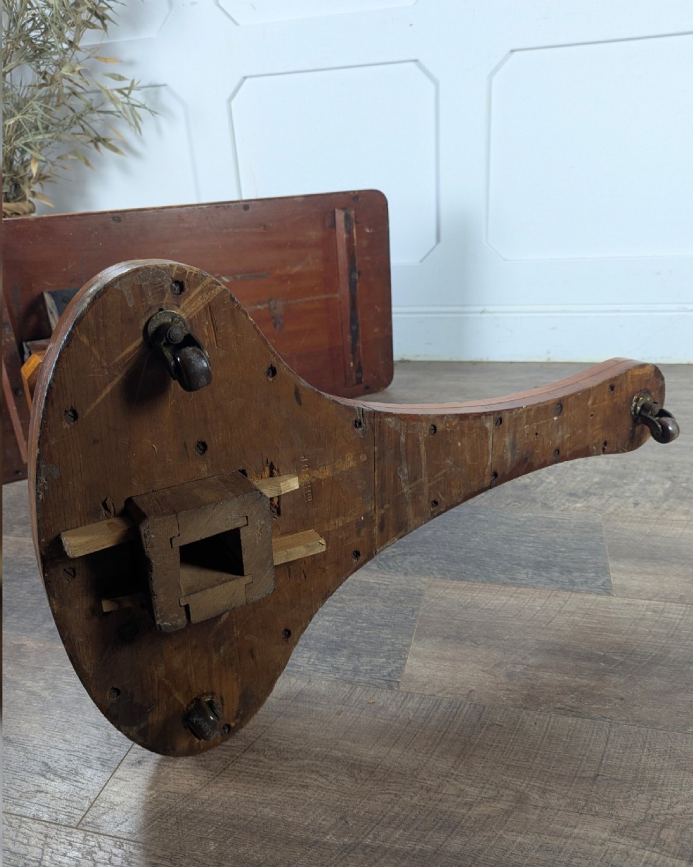 An early 20th-century pine reading table featuring an adjustable tilting top, a central turned support column, and a shaped base on small castors. View XIV