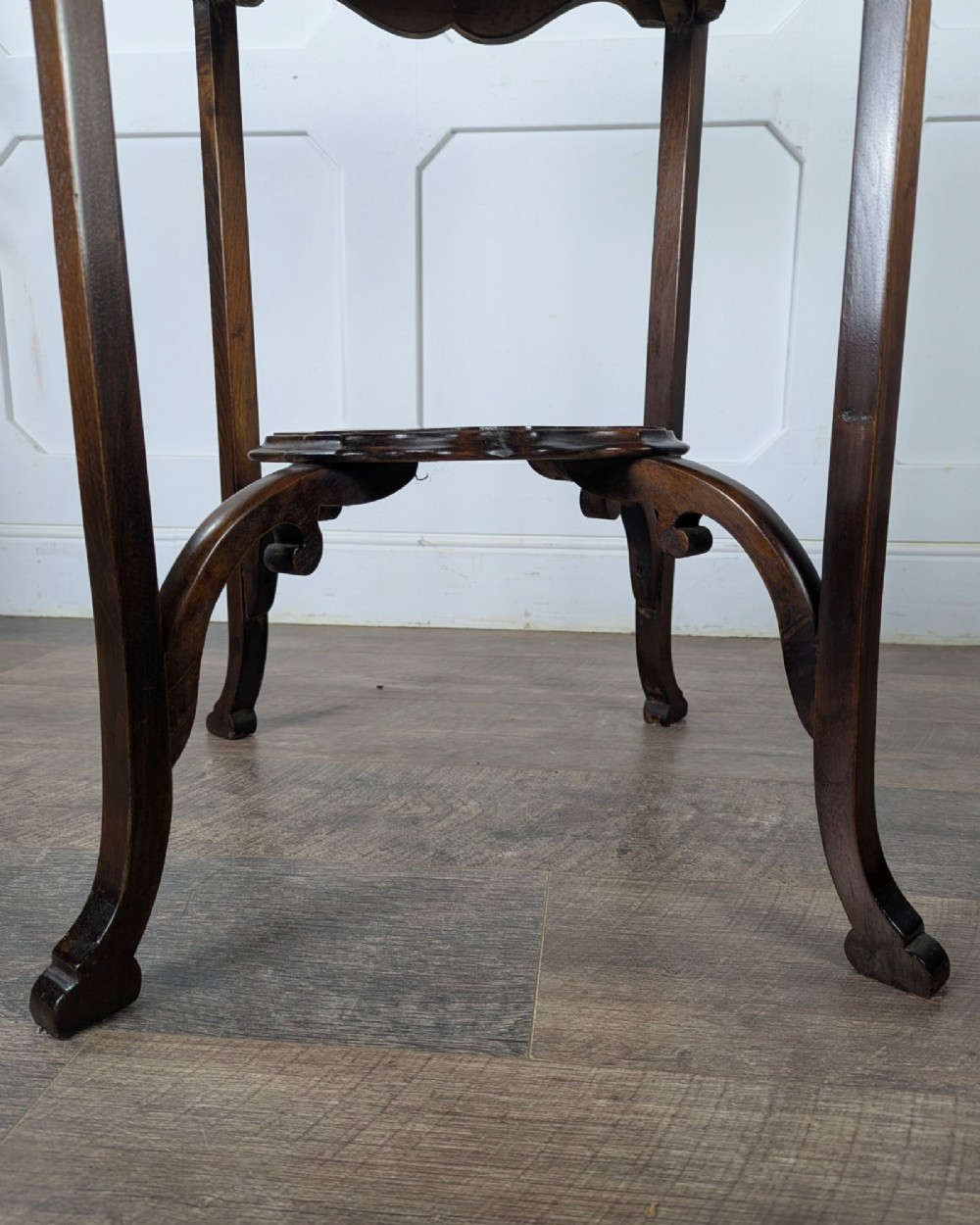 An early 20th-century walnut side table featuring a scalloped rim, carved legs, and a lower undertier shelf. View XII
