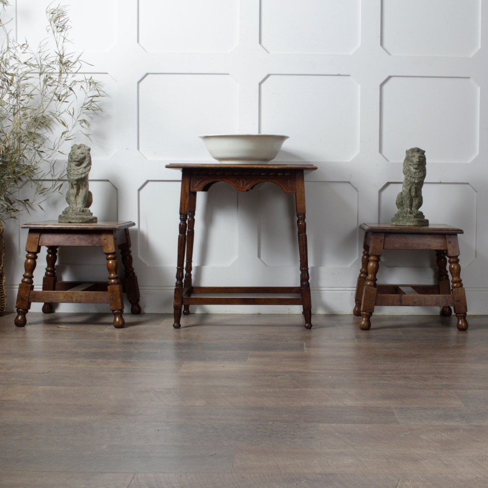 A late Victorian solid oak side table featuring carved apron arches, turned legs, and a rectangular top supported by low box stretchers. View II