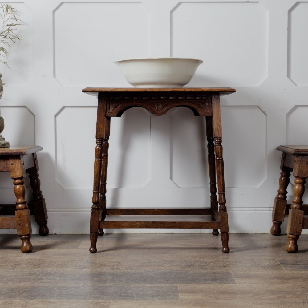 A late Victorian solid oak side table featuring carved apron arches, turned legs, and a rectangular top supported by low box stretchers. View III