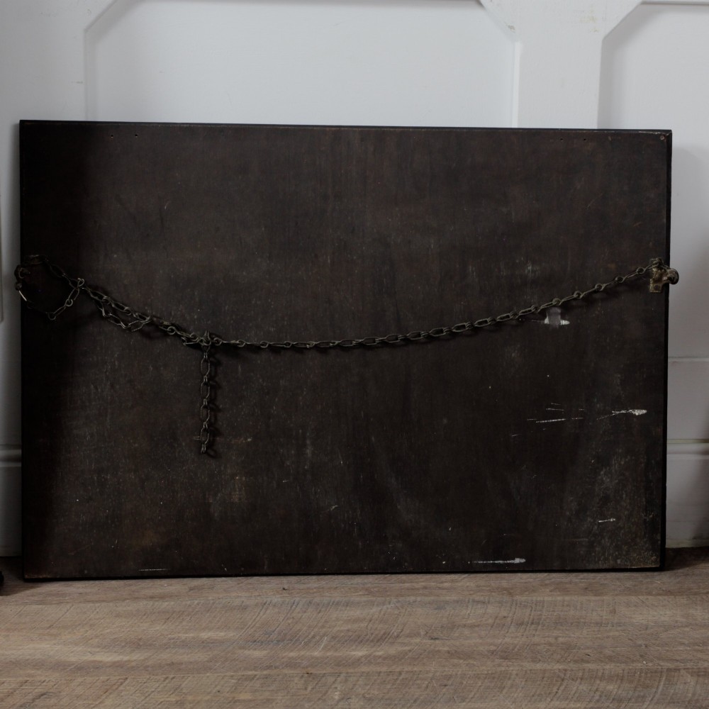 A rectangular dark oak wall mirror featuring a bevelled glass plate, beaded moulding around the frame, and applied wooden boss embellishments. View VI