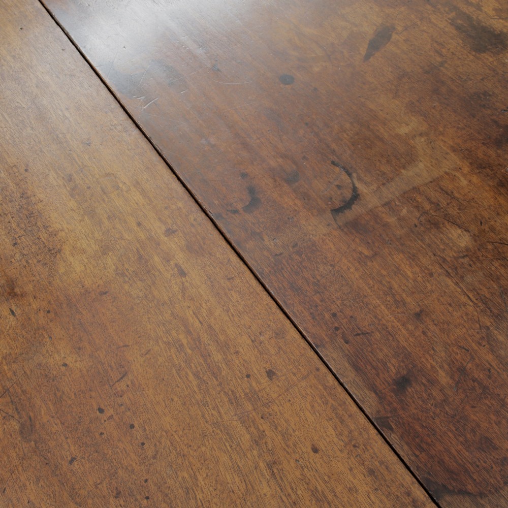 A pair of Georgian walnut demilune tables placed together to form a single round top with tapered legs. View XI