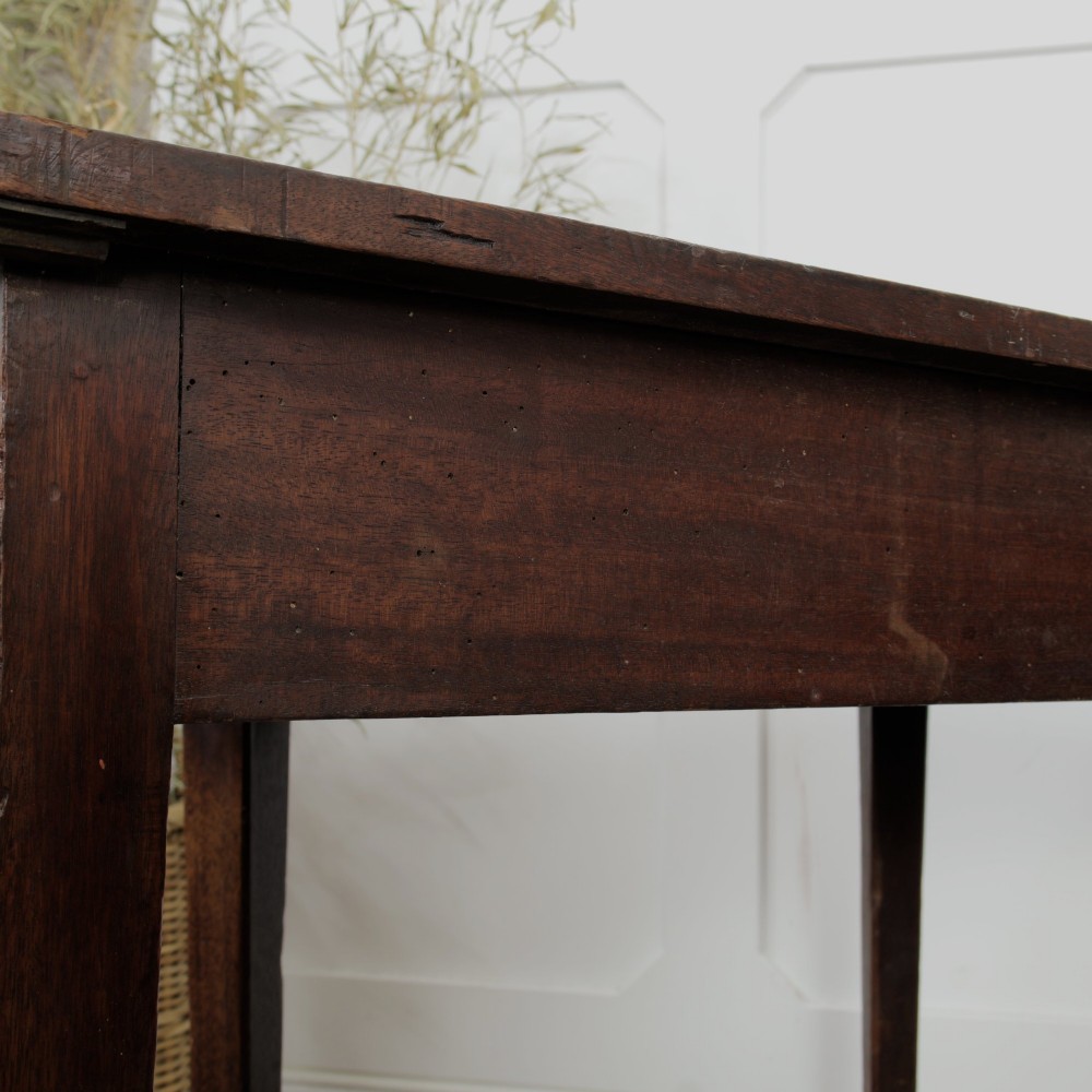 A pair of Georgian walnut demilune tables placed together to form a single round top with tapered legs. View XIII