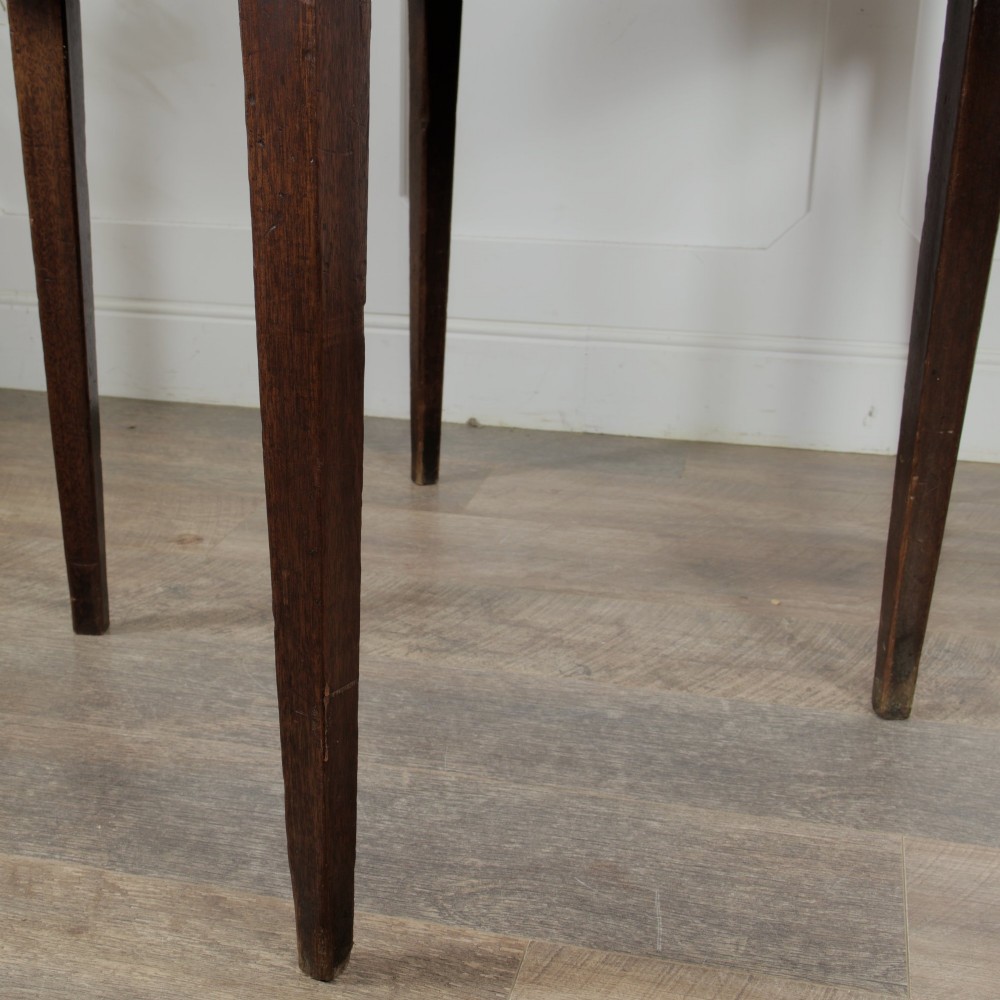 A pair of Georgian walnut demilune tables placed together to form a single round top with tapered legs. View XIV