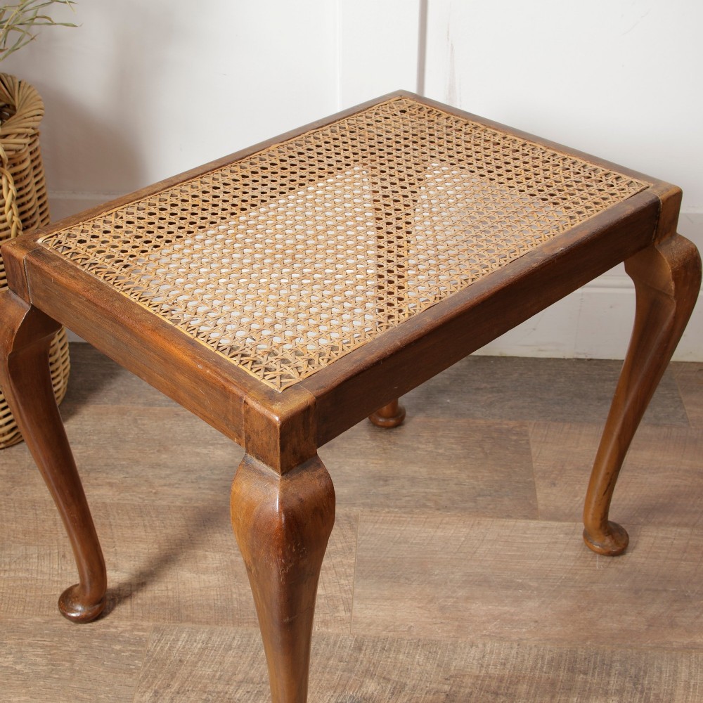A low walnut luggage stand featuring a rectangular woven rattan top supported by four cabriole legs with pad feet. View V