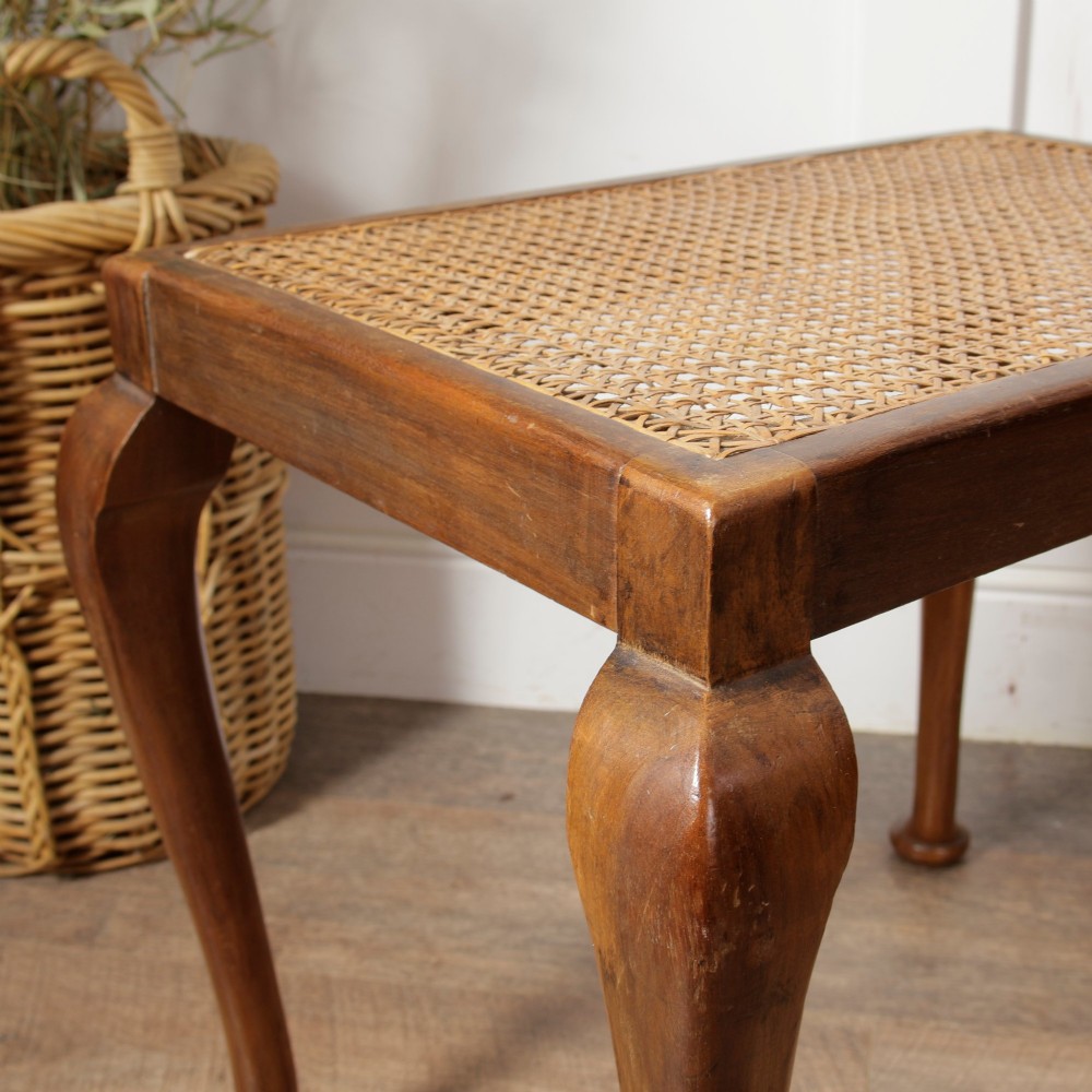 A low walnut luggage stand featuring a rectangular woven rattan top supported by four cabriole legs with pad feet. View VI